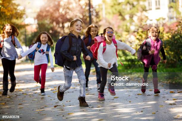School Kids Running In Schoolyard Stock Photo - Download Image Now - Child, School Building, Back to School
