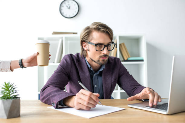 istock woman bringing coffee in paper cup 895496522