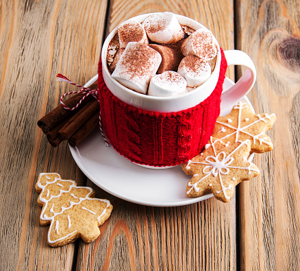 Cup of Christmas cocoa with decorations on a old wooden table