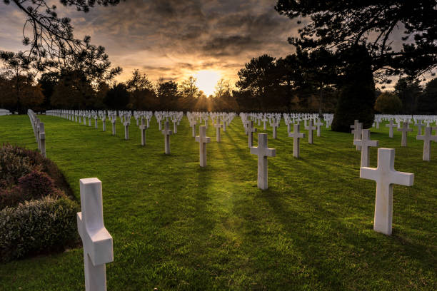 American Military Cemetery, Normandy, France The sun sets on the American Military Cemetery, Colleville-sur-Mer, Normandy, France normandy stock pictures, royalty-free photos & images