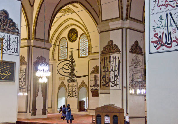 Grand Mosque Turkish Ulu Cami Bursa, Turkey - May 14, 2017: People are praying in Grand Mosque Turkish Ulu Cami. The mosque is most important mosque in Bursa and a landmark of early Ottoman architecture built in 1399. ulu camii stock pictures, royalty-free photos & images