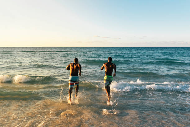 istock Two cuban friends having fun in the beach. 895507322
