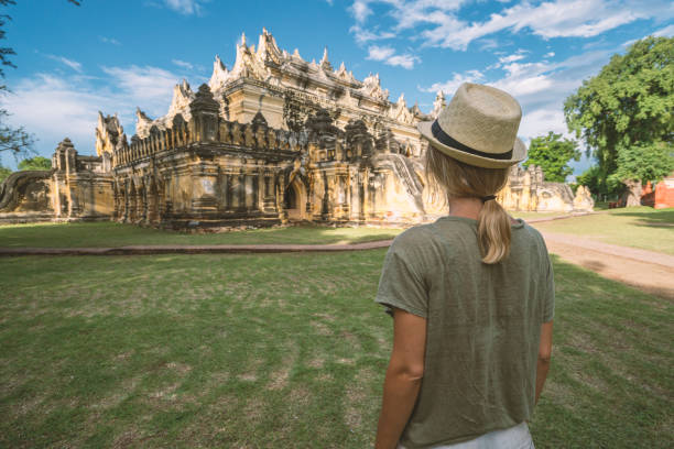 istock Young woman visiting temple in Myanmar 895511260