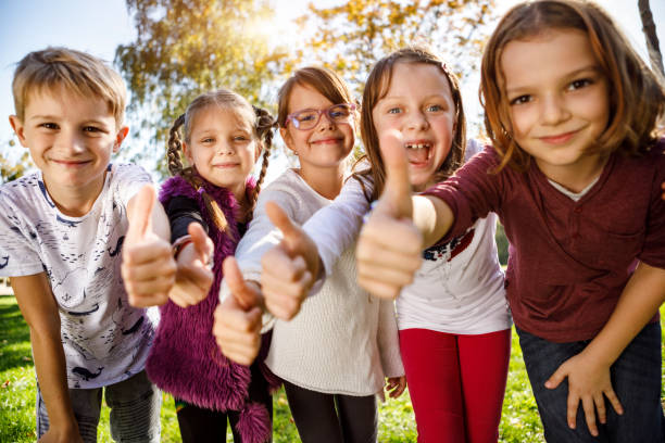 Group of children giving thumbs up