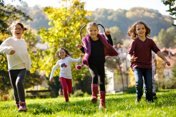 istock Group of happy children playing outside 895515854