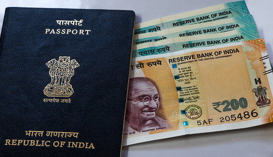 Image of Indian passport with paper currency