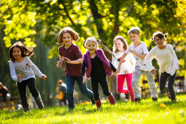 istock Group of school children running on school playground 895518566