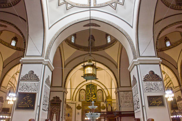 Grand Mosque Turkish Ulu Cami Bursa, Turkey - May 14, 2017: People are praying in Grand Mosque Turkish Ulu Cami. The mosque is most important mosque in Bursa and a landmark of early Ottoman architecture built in 1399. ulu camii stock pictures, royalty-free photos & images