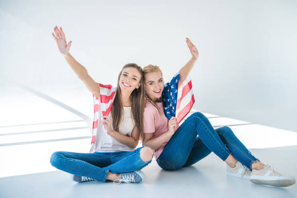 istock girls with american flag 895523216