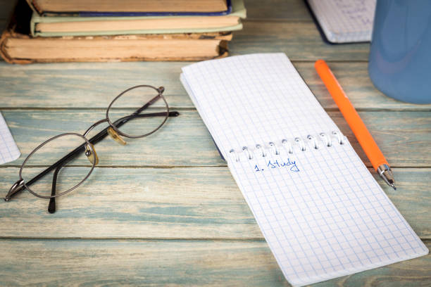 istock Education concept. Notebook page with the word  study on wooden table 895523648