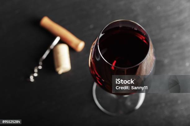 Wine Glass Of Red Wine With A Corkscrew Stock Photo - Download Image Now - Wine, Red Wine, Wineglass