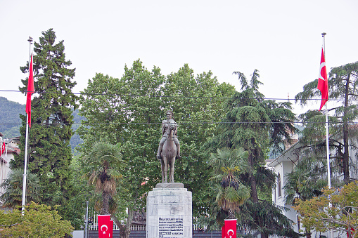 Bursa, Turkey - May 14, 2017: People on the way in Bursa central square where a big Statue of Ataturk greets the city, Heykel district of Bursa, Turkey's forth largest city.