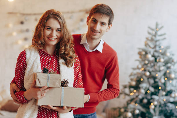 istock Happy young couple with Christmas presents 895530594