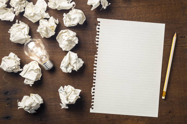 Start Writing Idea Paper and pencil with glowing light bulb among the crumpled rubbish for writing concept creative writing class stock pictures, royalty-free photos & images