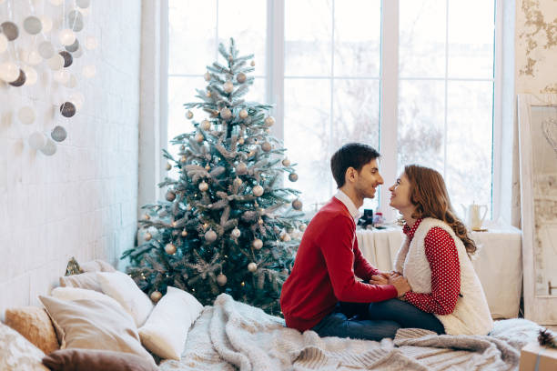 istock Happy loving couple enjoying Christmas 895535062