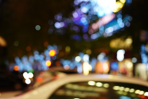 Defocused urban abstract texture bokeh city lights & traffic jams in the background with blurring lights.