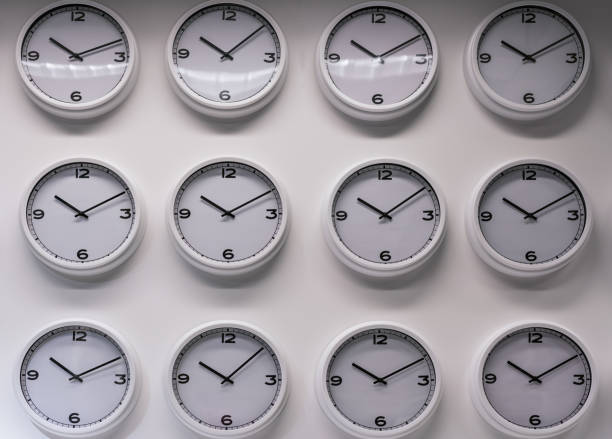 istock Rows of white plastic wall watches on the white background. 895552596