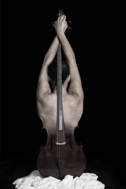 Fascinating photo of cello merged into the beautiful sculpted muscle back of a woman stock photo