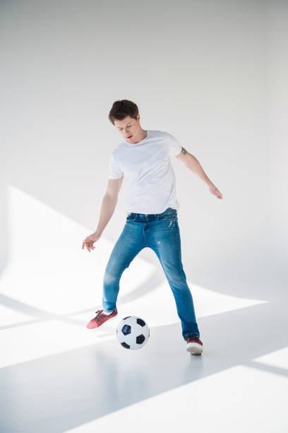 istock young man with soccer ball 895571582