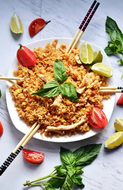 Super easy and delicious Thai Chicken Fried Rice with basil and tomatoes.
