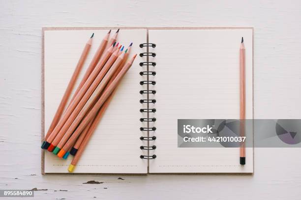 Open Sketchbook And Pencil On Old White Wooden Table Stock Photo - Download Image Now