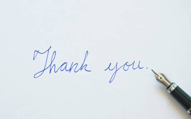 istock fountain pen write thank you word on white paper 895594998