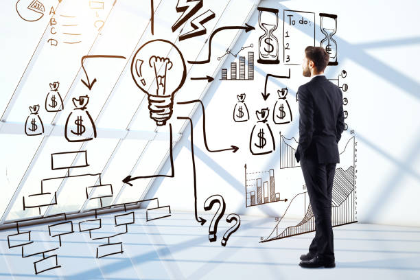 istock Businessman looking at business sketch 895606076