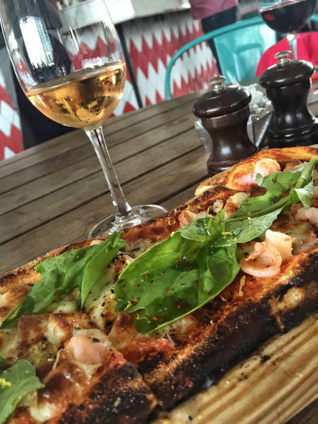 istock pizza and a glass of wine on table 895610192