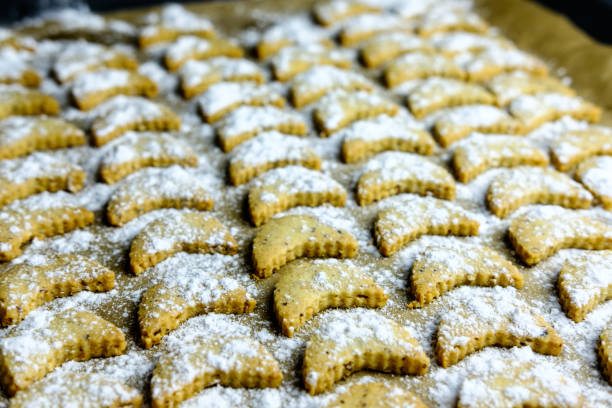 istock Baked vanilla half moon cookies on baking tray 895612860