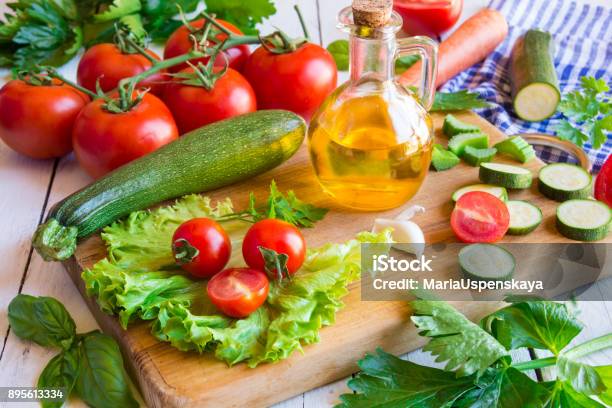 Olive Oil Tomato And Other Cut Vegetables Stock Photo - Download Image Now - Healthy Eating, Basil, Chopped Food