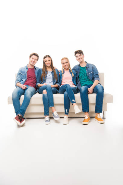 istock young friends sitting on sofa 895617734