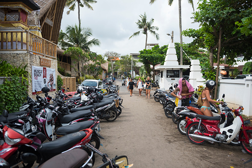 Canggu, Bali - October 8, 2017: Scooters are parked outside Finns Beach Club, a popular beachside establishment in Canggu, Bali.