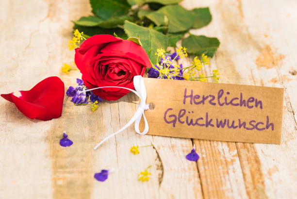 istock Bunch of flowers with congratulation card 895623096