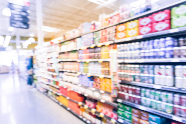 istock Blurred soda, bottled tea, juices in retail store 895623448