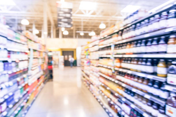 istock Blurred soda, bottled tea, juices in retail store 895625714