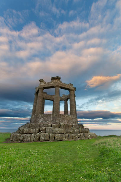 Sunset at Second World War Memorial near Stonehaven on the Scottish coast with moving cloud