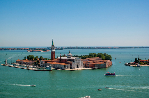 Aerial view of boats moored at harbor and island with Church of San Giorgio Maggiore surrounded with seascape at Venice,Italy