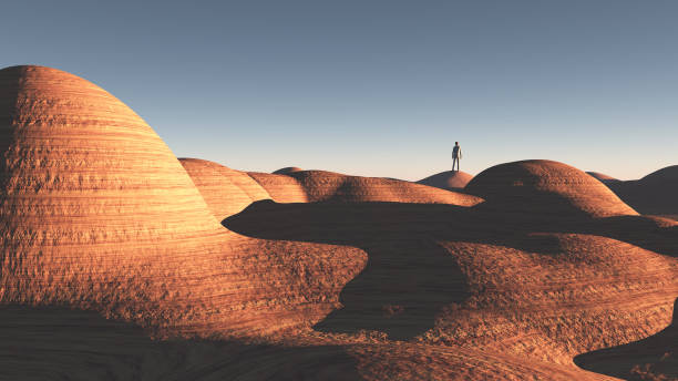 istock Man stands in rock desert 895667032