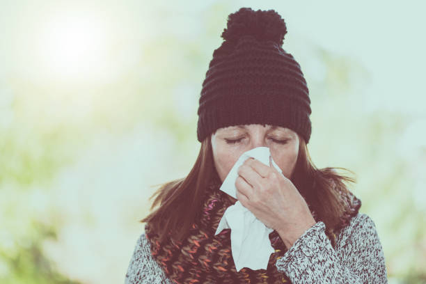 istock Woman blowing her nose 895671478