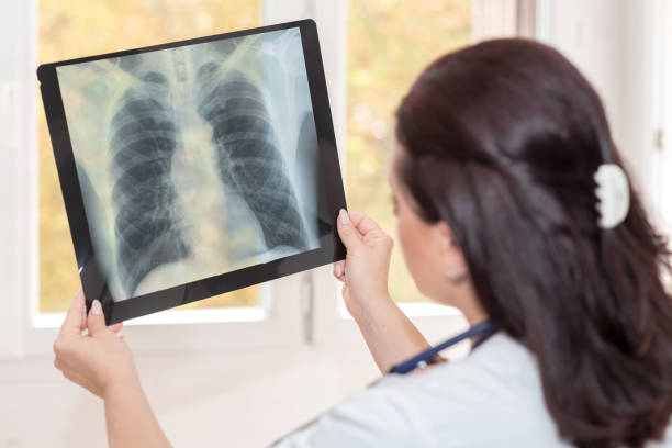 istock Doctor examining x-ray report 895672008