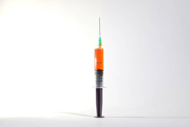 Syringe isolated on red background. 3d illustration.