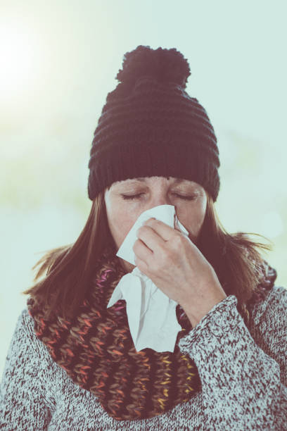 istock Woman blowing her nose 895674552