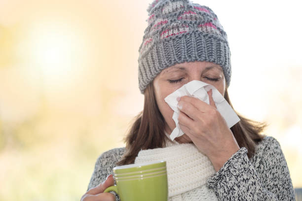 istock Woman blowing her nose, light effect 895674640