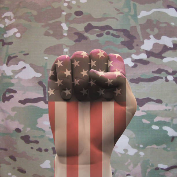 istock USA Clenched Fist on Camouflage Background 895674708