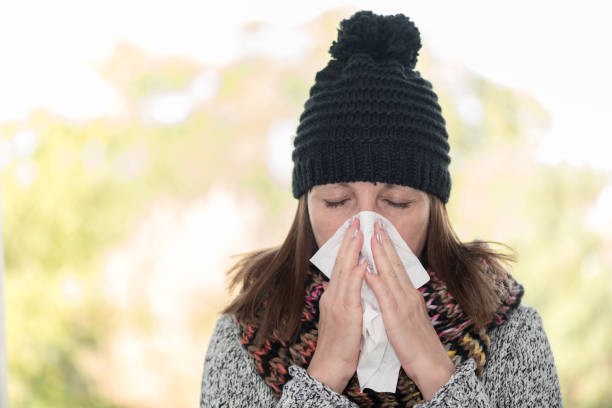 istock Woman blowing her nose 895674994