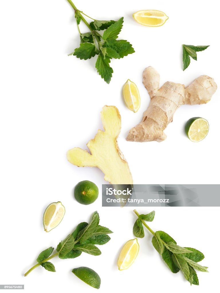 The concept of healthy eating. Vegetables and fruits isolated on white background. The concept of healthy eating. Vegetables and fruits isolated on white background. Composition from the root of ginger, slices of lemon and lime, leaves of mint,  with copy space. Ginger - Spice Stock Photo