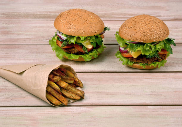 istock Hamburgers with salad and cheese on a table 895678406