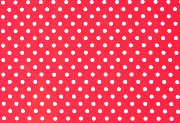Photo of Red fabric background texture with white polka dots