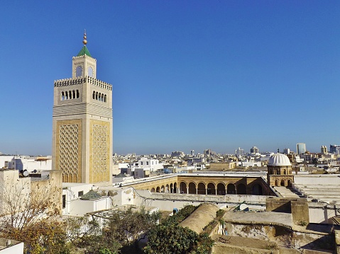 View of the Al-Zaytuna Mosque and the skyline of Tunis. The mosque is a landmark of Tunis. In the background the modern buildings of the new City or \