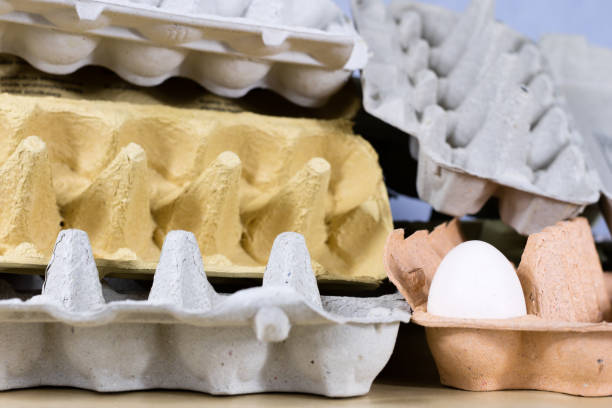 Eggs in molds on a wooden kitchen table. Hen egg in the kitchen atmosphere. black background